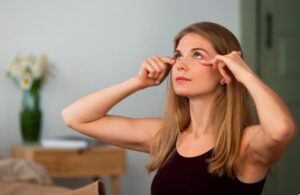 Vue latérale d'une femme pratiquant le yoga facial